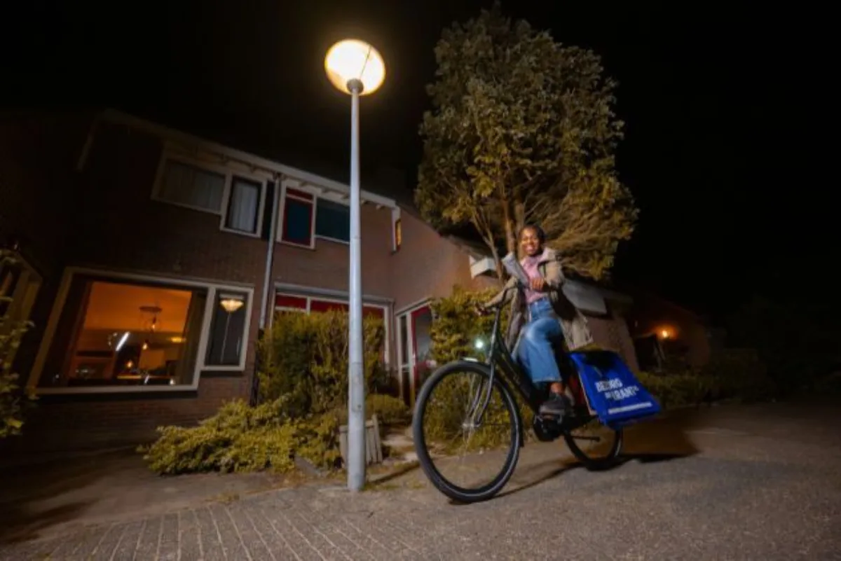 Slider image Krantenbezorgster onderweg op de fiets